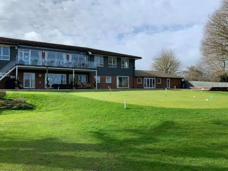 Hazlemere clubhouse behind the putting green
