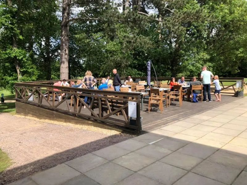 Golfers relaxing at tables on the clubhouse terrace